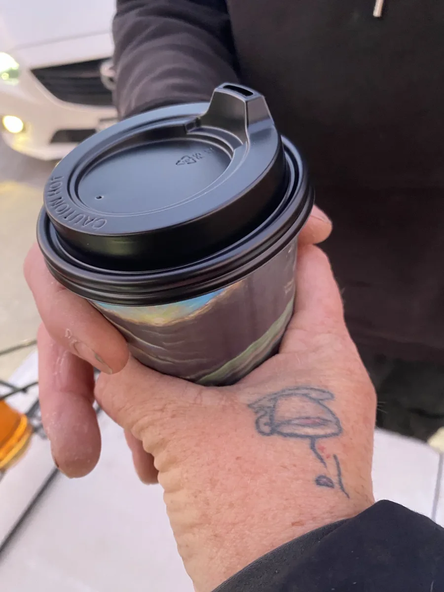 A freshly served takeaway coffee